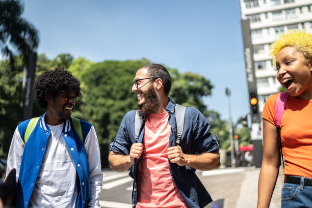istock Friends talking and walking in the street 1385188546