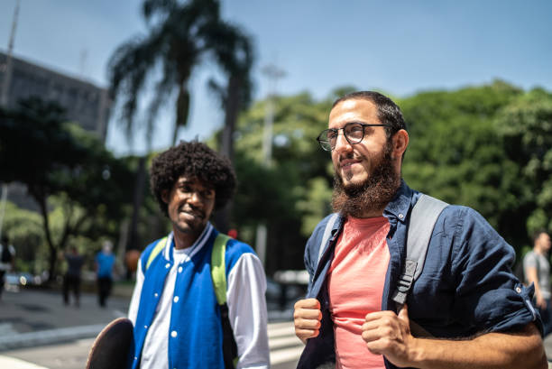 istock Students friends walking in the street 1385188551