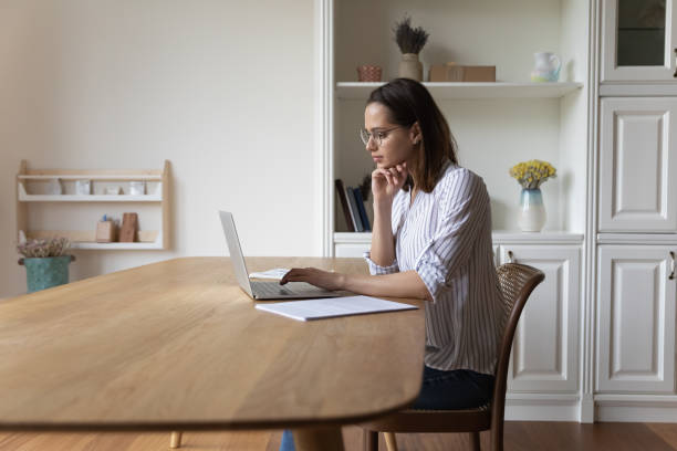 istock Young woman in glasses studying or working online use computer 1385188686