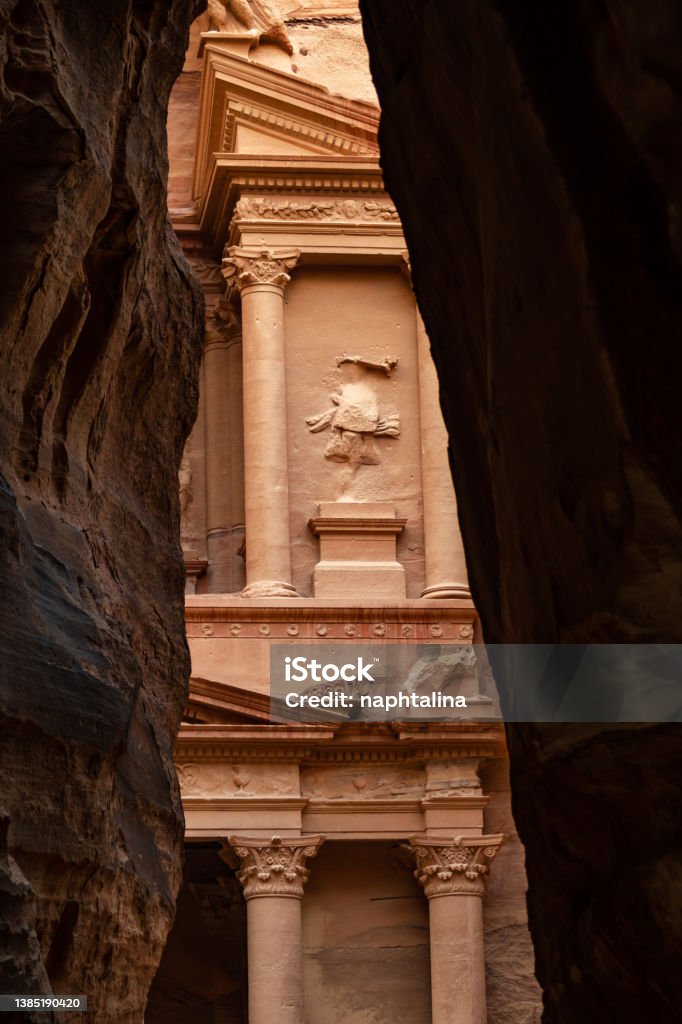 Al-Khazneh ("The Treasury"‎‎) is one of the most elaborate temples in the ancient Arab Nabatean Kingdom city of Petra. This structure was carved out of a sandstone rock face. Facade seen from the canyon. Adventure Stock Photo