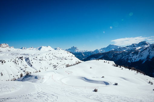 Ski lift and ski slope in Dolomites, Italy. Panoramic view of Val di Fassa.