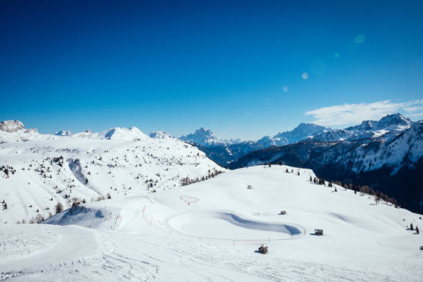 Ski lift and ski slope in Dolomites, Italy. Panoramic view of Val di Fassa. stock photo