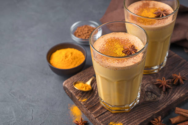 istock Immuno-supportive drink with milk, turmeric, coffee and cinnamon on a dark background 1385190609