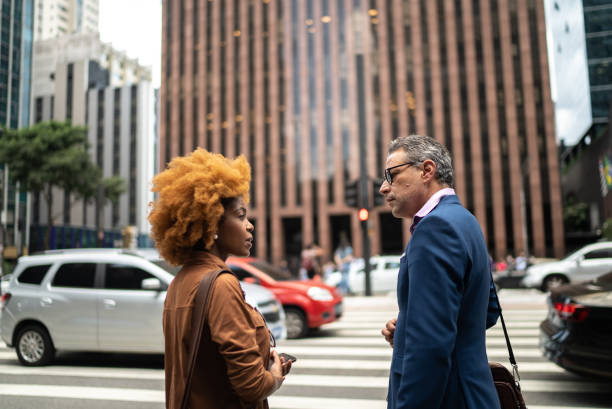 istock Coworkers talking and walking in the street 1385190764