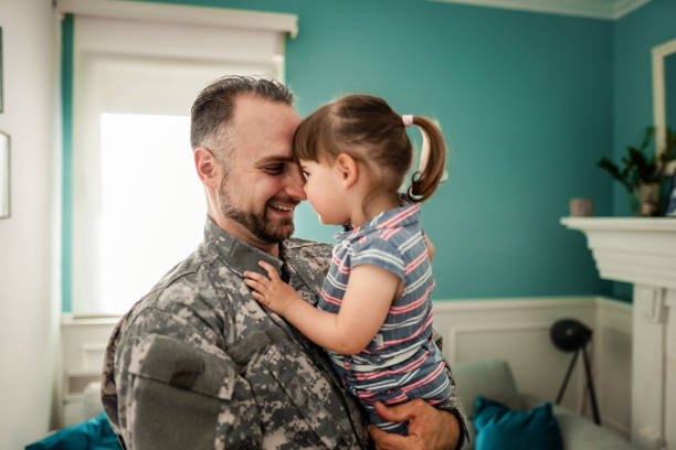 istock Army father hug his daughter , after returned from military assignment 1385190940