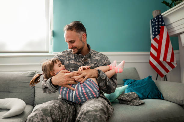 istock Army father hug his daughter , after returned from military assignment 1385190963
