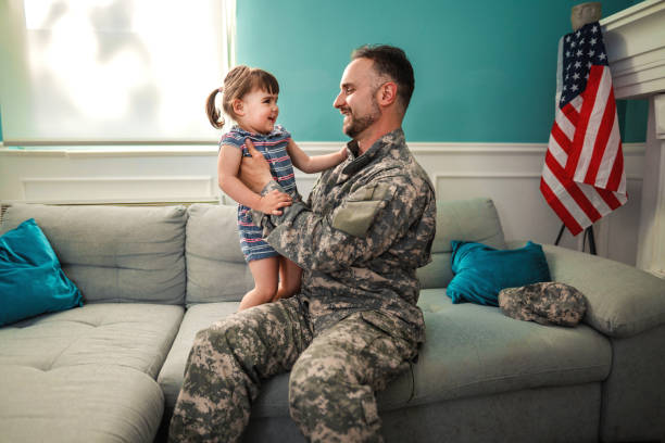 istock Army father hug his daughter , after returned from military assignment 1385191491