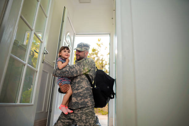 istock Army father hug his daughter , after returned from military assignment 1385191549
