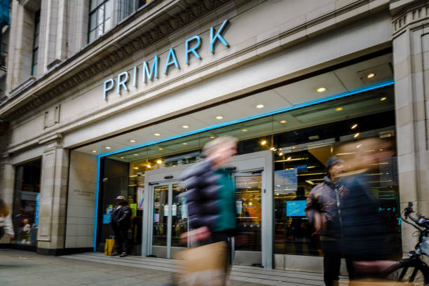 Exterior of Primark clothing store with blurred motion of people on city street stock photo