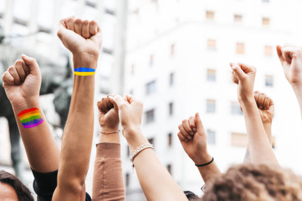 istock Group of people with a Ukrainian flag on hands marching for peace 1385193123