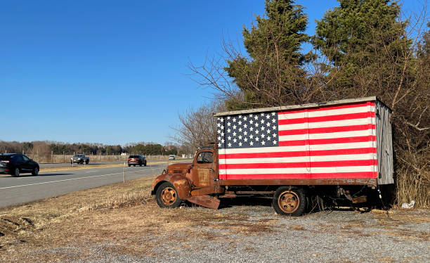 istock old truck with flag alongside the highway 1385194391