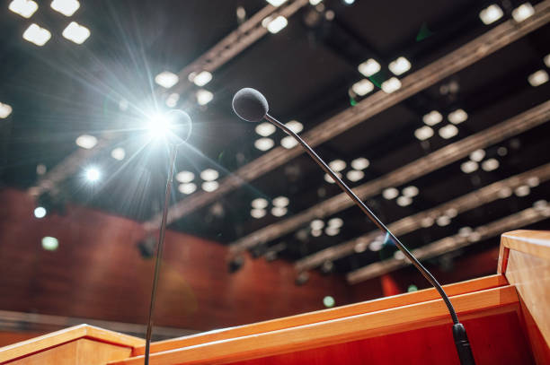 istock Microphones on a lectern in a conference rooms 1385194488