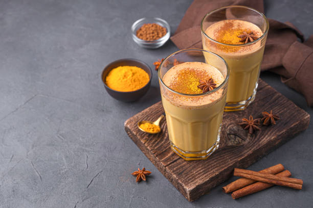 istock Cappuccino with Indian turmeric, anise and cinnamon on a dark background 1385194586