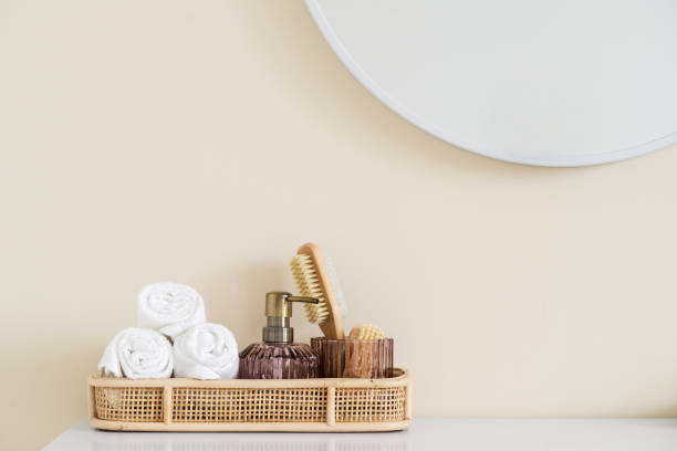istock Bamboo tray with rolled towels and personal accessories in hotel 1385195377