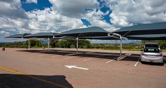 Car parking with awnings to create shade from the sun in Africa.  Parking area with anti-sun soft roofs to protect from the rays of the sun in South Africa.