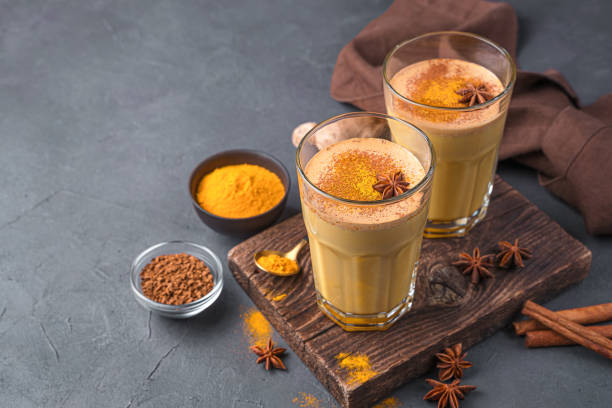 istock Healthy milk drink with turmeric, coffee and cinnamon on a dark background 1385196861