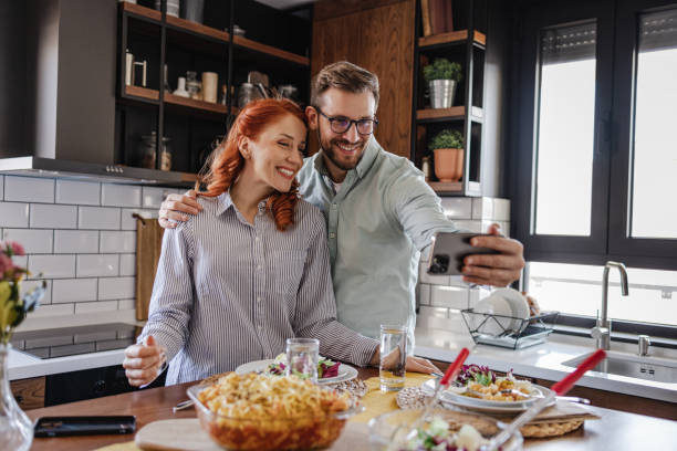 istock Happy couple taking selfie in the kitchen 1385197058