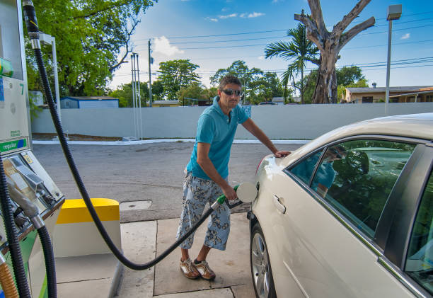 Happy man refueling car at self service gas station