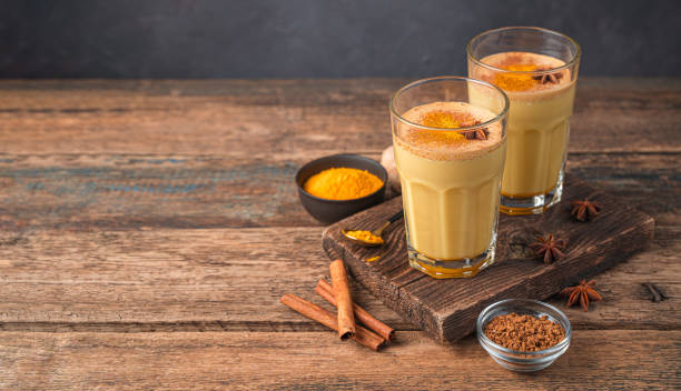 istock Turmeric latte with cinnamon and anise on a wooden background 1385199297
