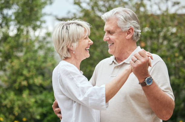 Shot of a senior couple sharing a dance while standing outside