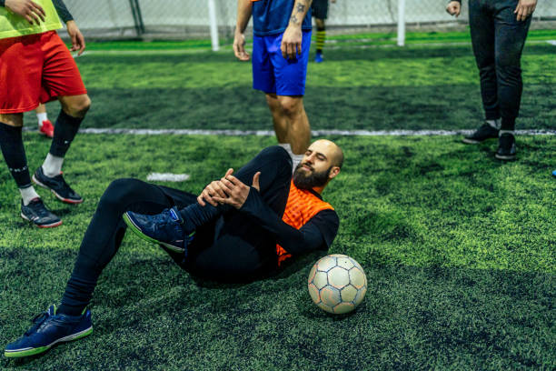 istock Soccer player holding his injured leg 1385201393