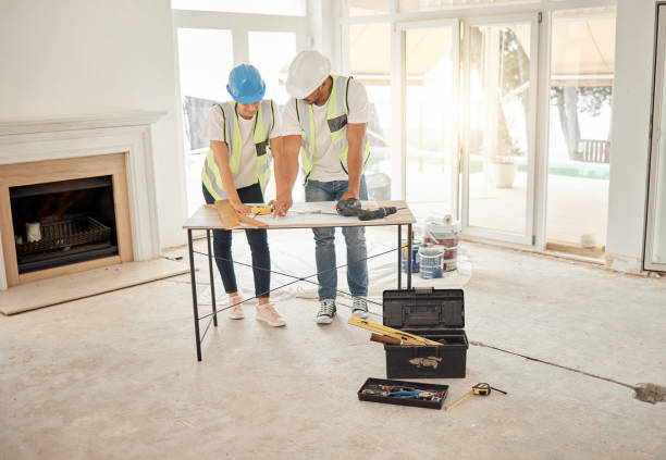 istock Full length shot of two unrecognisable construction workers standing inside together and have a discussion over the architecture plans 1385202046