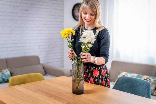 istock Arranging flowers in her home 1385202523