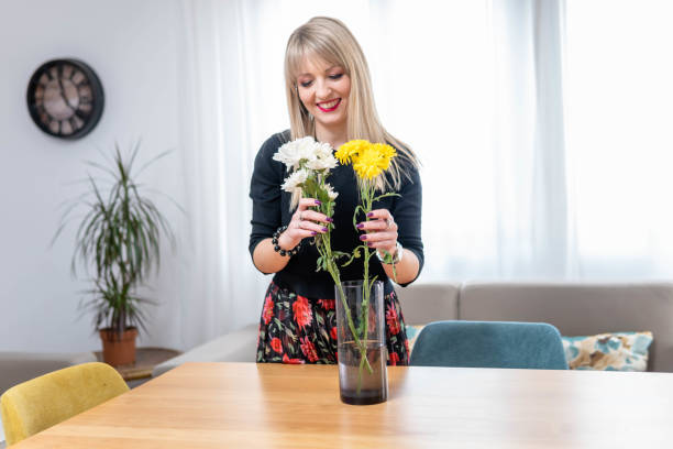 istock Arranging flowers in her home 1385202533