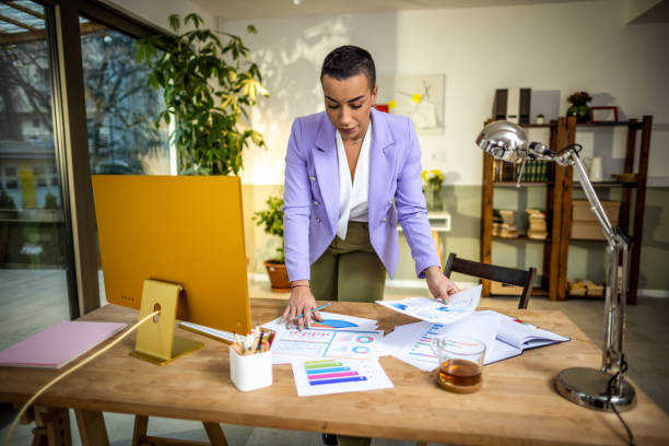 istock Young woman working on a computer in her home office 1385202673