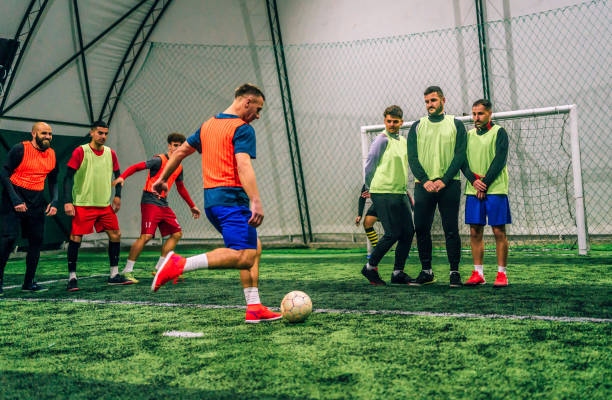 istock Player kicking ball over the human defensive wall 1385202764
