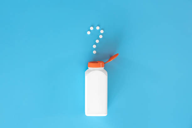 istock Pills on blue background, flat lay, medicine concept. 1385203527