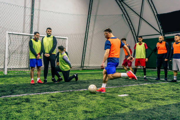 istock Player kicking ball over the human defensive wall 1385203553