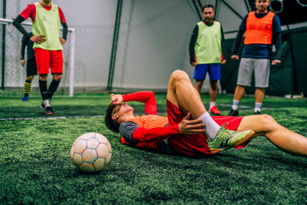 istock Soccer player holding his injured leg 1385203774