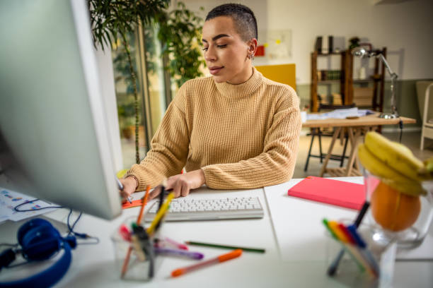 istock Young woman working on computer at her home office 1385203917
