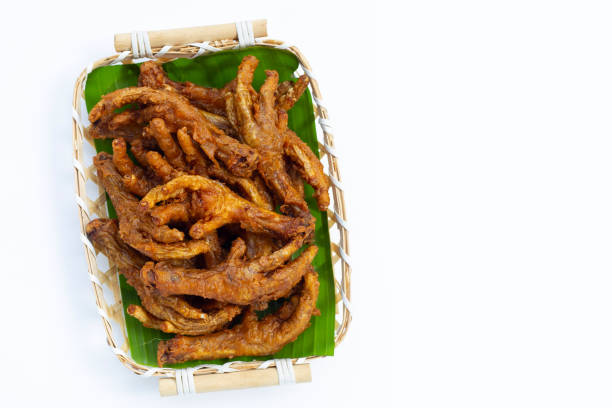 istock Fried chicken feet in bamboo basket on white background. 1385203957