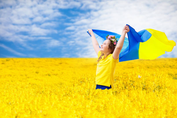 istock Pray for Ukraine. Child with Ukrainian flag. 1385206345