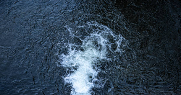 istock Natural waterfall, top view, water texture and foaming waves. 1385207020