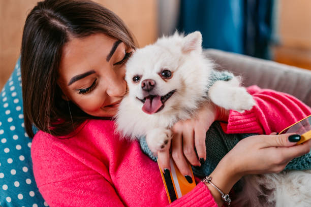 istock Young Woman Cuddling With Her Dog 1385207683