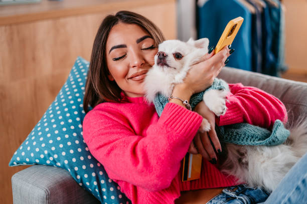 istock Young Woman Cuddling With Her Dog 1385208259
