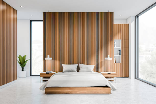 istock Bright bedroom interior with bed, panoramic window with town view, 1385208462