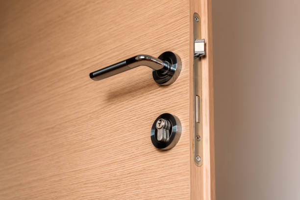 istock Modern metallic door handle on medium density fiberboard bedroom door 1385208477