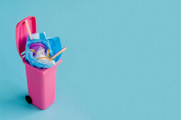 istock Studio shot of a pink big trash on blue background 1385216916