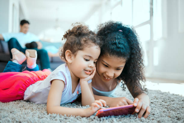 istock Shot of two sisters using a digital tablet at home 1385218933