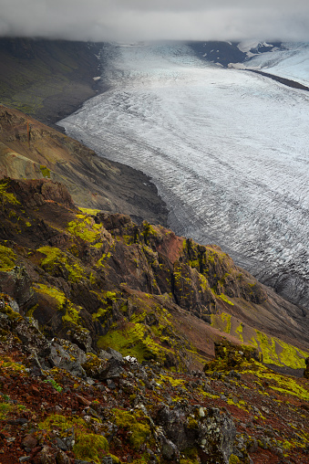 The Skaftafellsjökull glacier tumbling down the cloud-covered ice cap, as seen from the Skaftafellsheidi hiking trail, Skaftafell, Vatnajökull National Park, Iceland