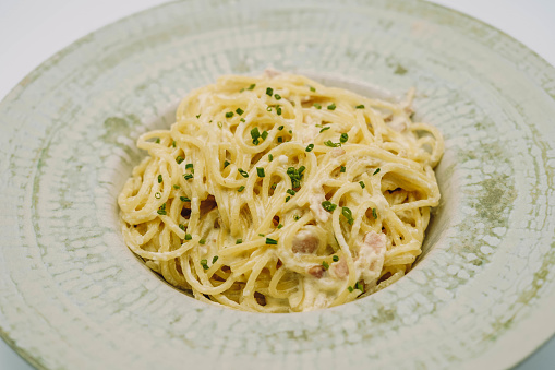 A plate of fresh pasta with alfredo sauce