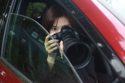 A woman taking a picture from inside the car