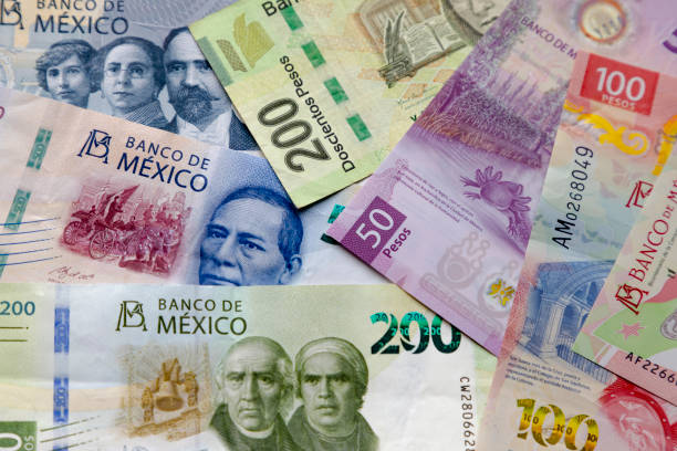 several mexican banknotes of different currencies. concept: inflation volatility - capital letter fotos imagens e fotografias de stock