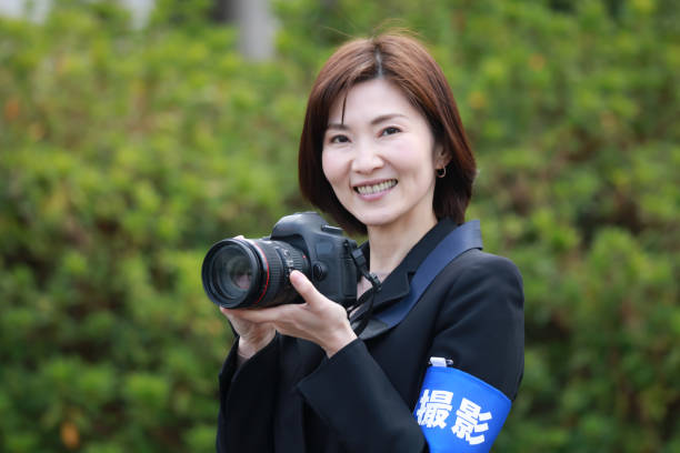 istock Female cameraman 1385229325