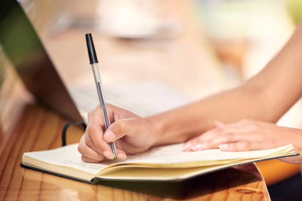 istock Shot of a nursery owner using a laptop and making notes 1385232385