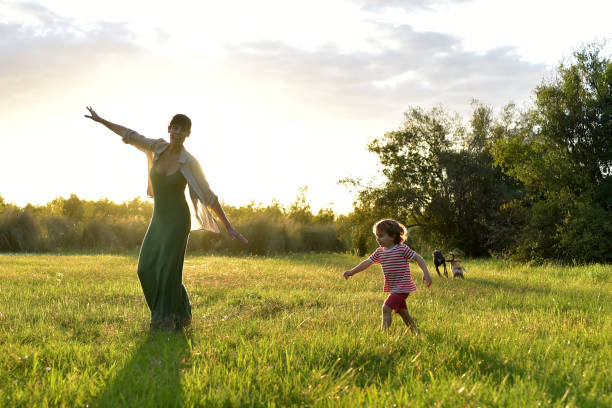 istock mother playing outdoors with her children 1385235041
